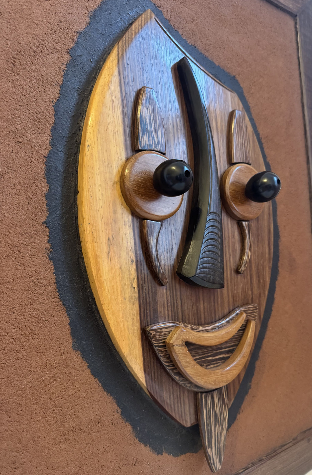 Hand-carved wood relief by Gabonese artist Casimir Zinga